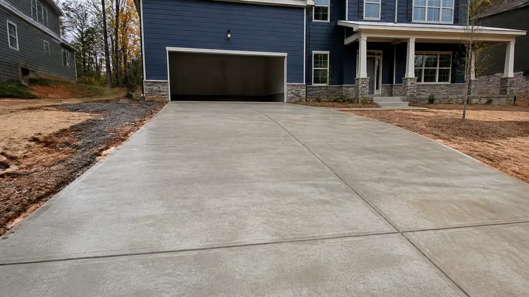 concrete installation completed by a local contractor at a brick-and-siding two-story home in Marietta, GA, after a rain shower.